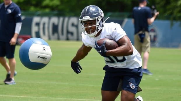 Titans running back Darrynton Evans (32) knocks down a heavy ball as he runs drills during practice at Saint Thomas Sports Park Thursday, May 27, 2021 in Nashville, Tenn.